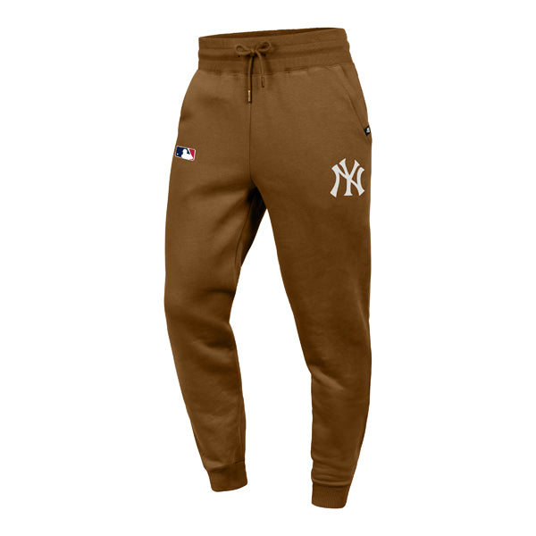 The model is wearing these MLB New York Yankees Islington ’47 Track Pants in dark brown. 1