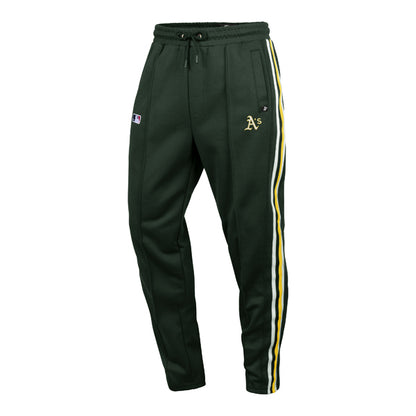 The model is wearing these MLB Oakland Athletics Jetway ’47 Track Pants in dark green. 1