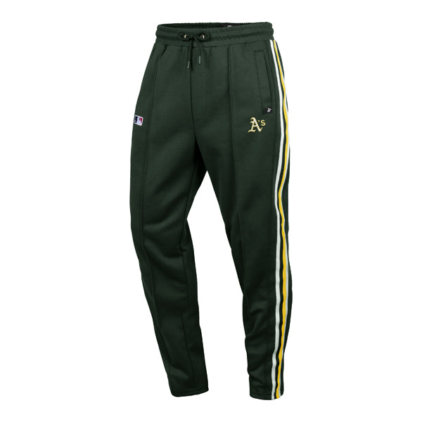 The model is wearing these MLB Oakland Athletics Jetway ’47 Track Pants in dark green. 1